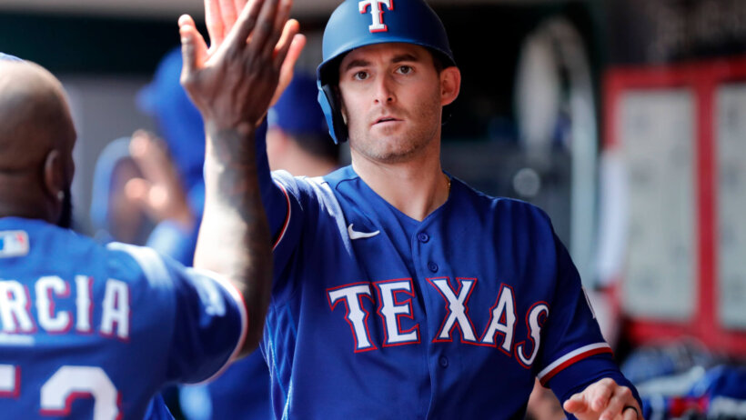 Texas Rangers designated hitter Brad Miller high-fiving teammates