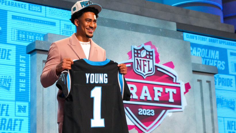 Bryce Young holding jersey during NFL Draft