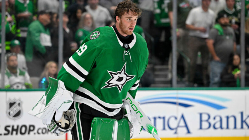 Dallas Stars goaltender Jake Oettinger skates off the ice after his helmet is dislodged