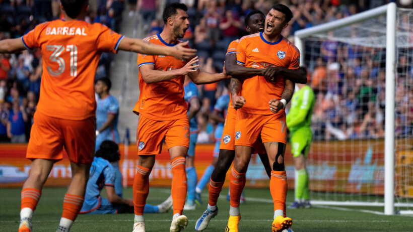 FC Cincinnati forward Dominique Badji (14) embraces FC Cincinnati forward Brandon Vázquez (19)