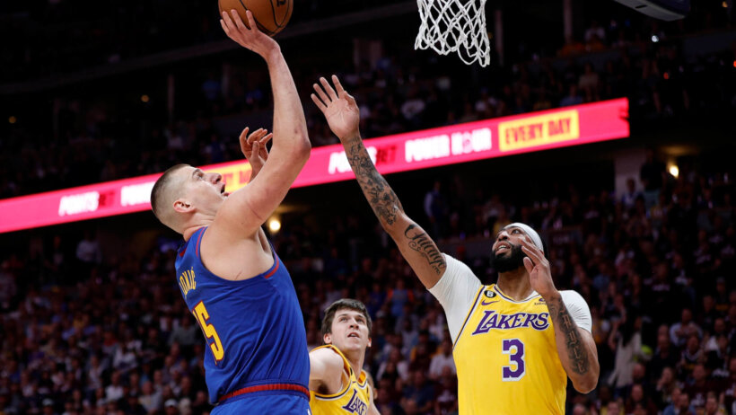 Nikola Jokic shoots over Anthony Davis