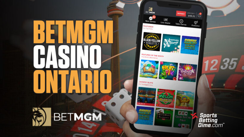 BetMGM Casino Ontario hand holding mobile phone with games