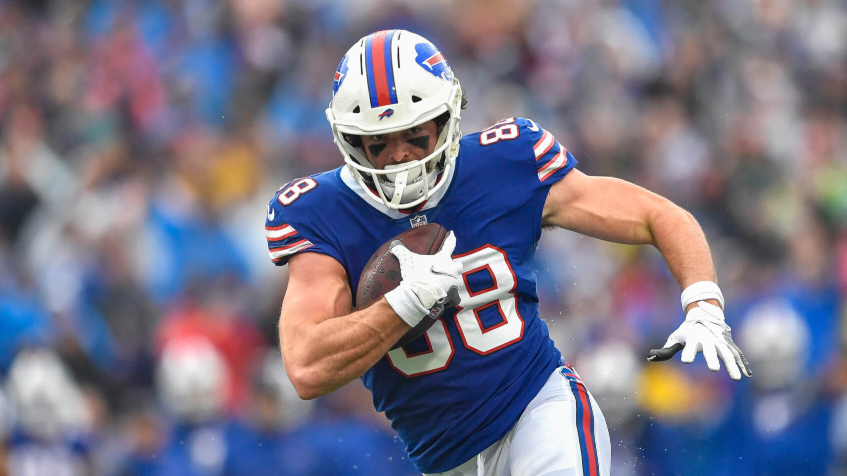 Buffalo Bills tight end Dawson Knox running with the ball during an NFL football game.