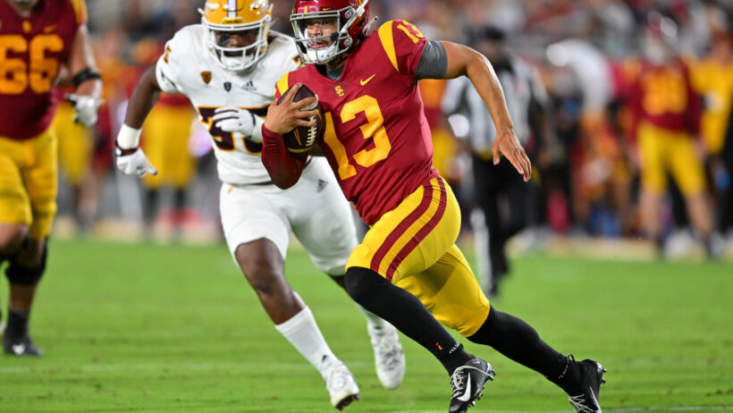 USC Trojans quarterback Caleb Williams runs with the football