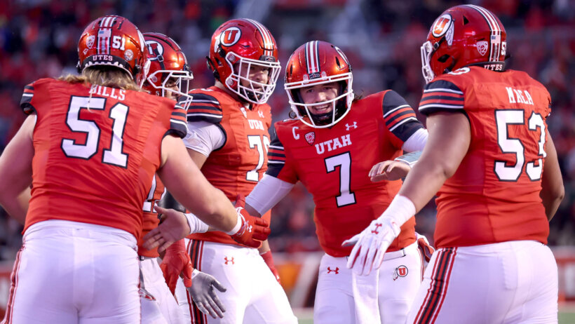 Utah Utes quarterback Cameron Rising (7) celebrates a touchdown with the offensive line