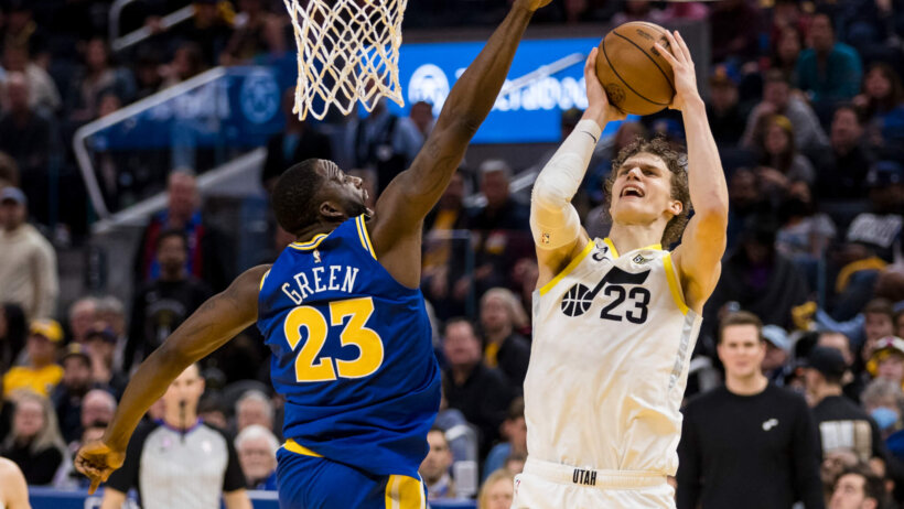 Golden State Warriors forward Draymond Green attempts to block Utah Jazz forward Lauri Markkanen