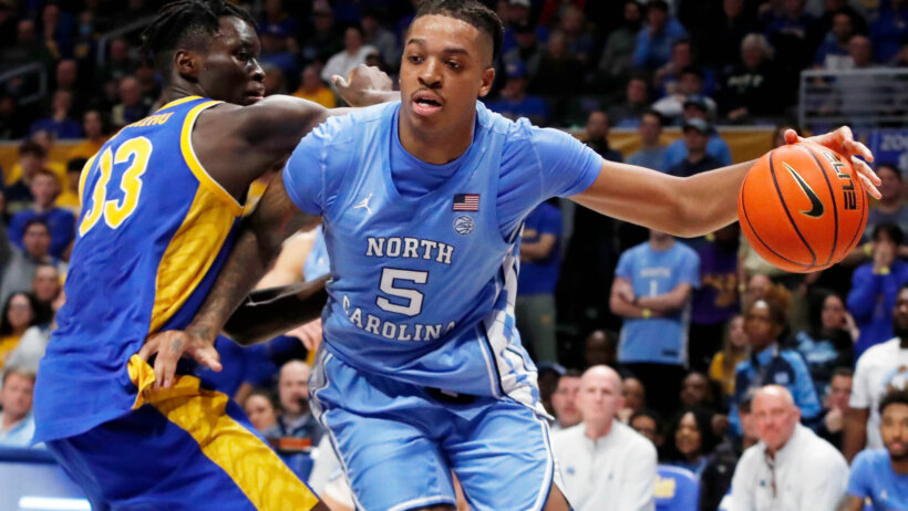 North Carolina Tar Heels forward Armando Bacot tries to dribble past Pittsburgh Panthers center Federiko Federiko