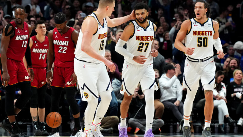 Nuggets celebrate in front of Miami Heat players