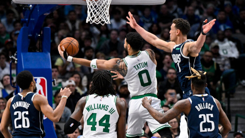 Boston Celtics forward Jayson Tatum goes for a layup against Dallas Mavericks defenders
