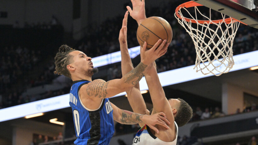 Orlando guard Cole Anthony goes for a layup against Minnesota center Rudy Gobert