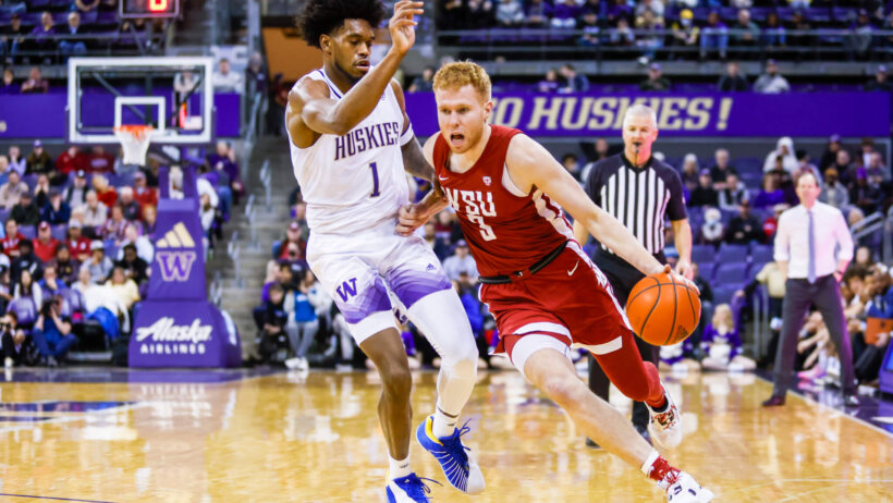 Washington State Cougars guard Kymany Houinsou drives around Washington Huskies forward Keion Brooks