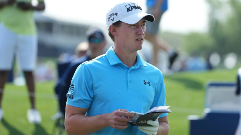 Maverick McNealy looking at his yardage book