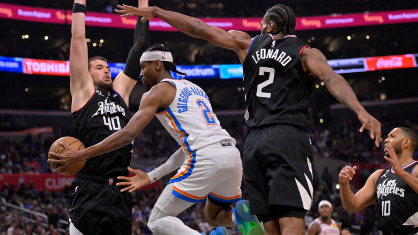 Oklahoma City Thunder guard Shai Gilgeous-Alexander makes a pass around Los Angeles Clippers center Ivica Zubac