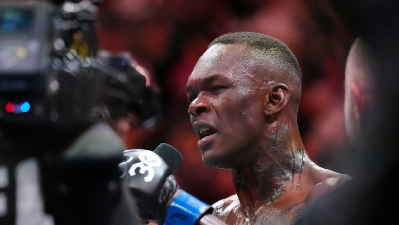 Israel Adesanya post fight interview holding mic