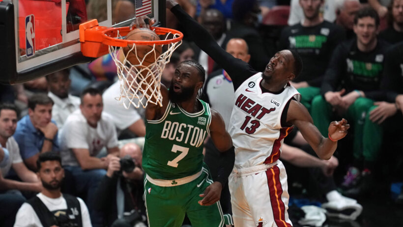Celtics Jaylen Brown dunking on Bam Adebayo of Heat