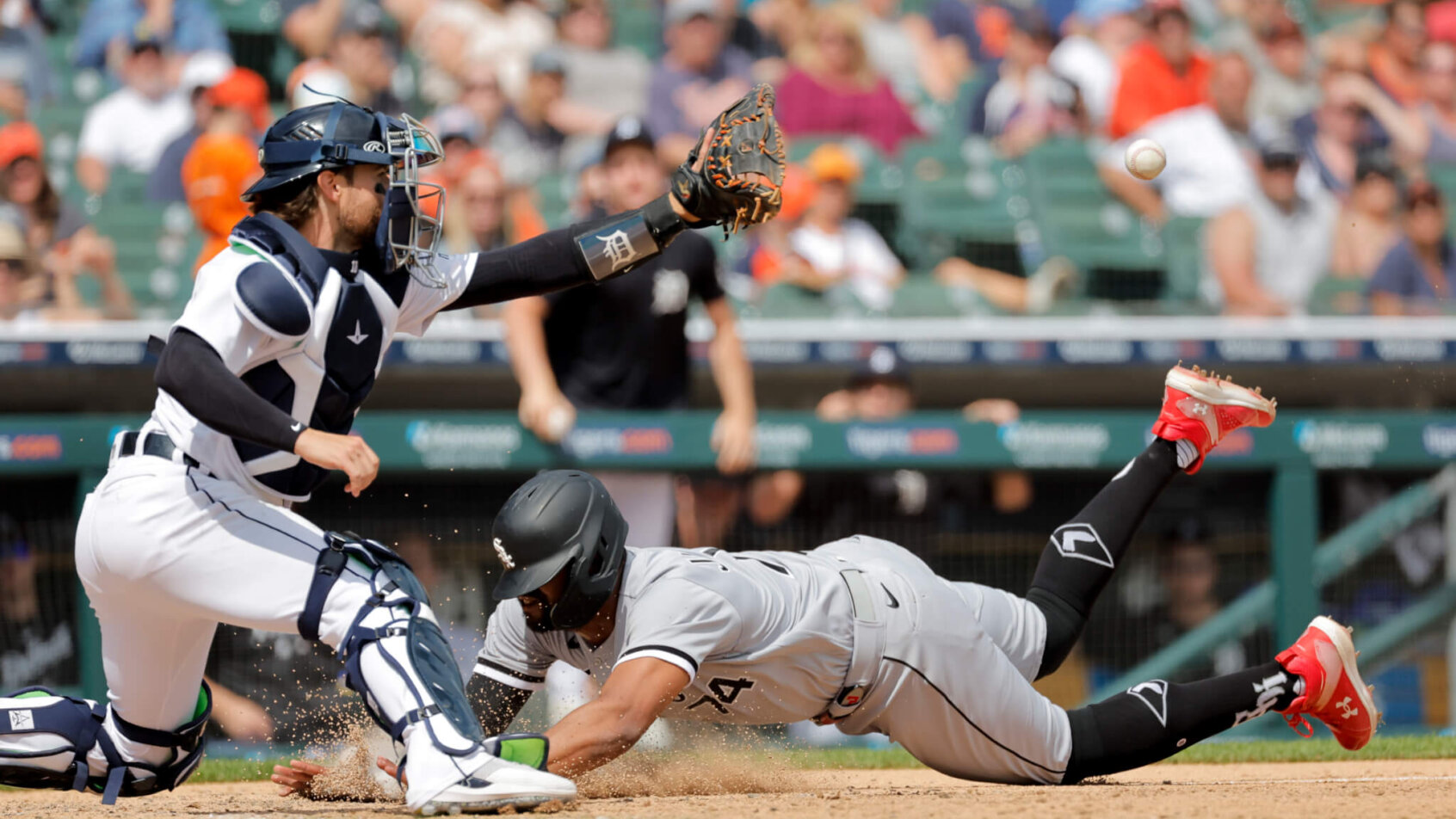 Eloy Jimenez of Chicago White Sox sliding home against Detroit Tigers.