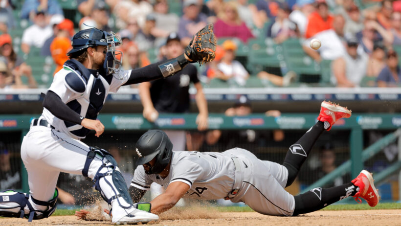 Eloy Jimenez of Chicago White Sox sliding home against Detroit Tigers.