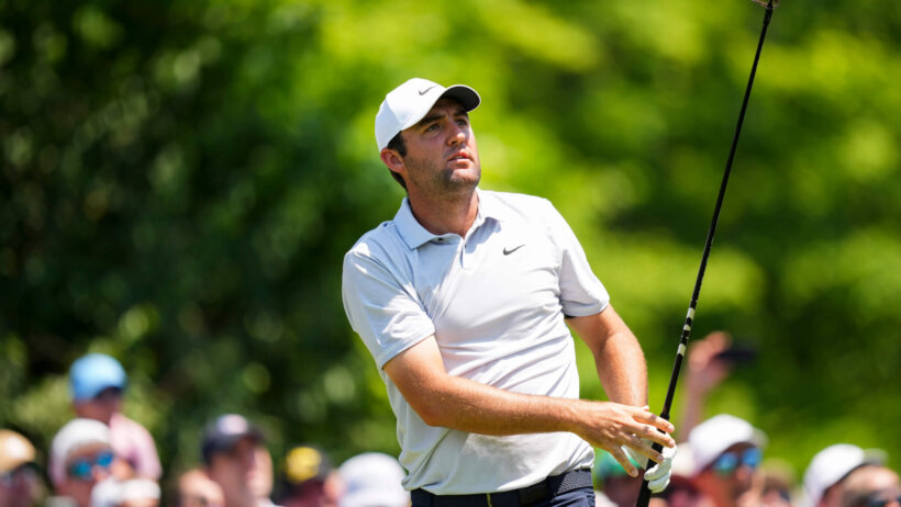Scottie Scheffler watches his approach shot