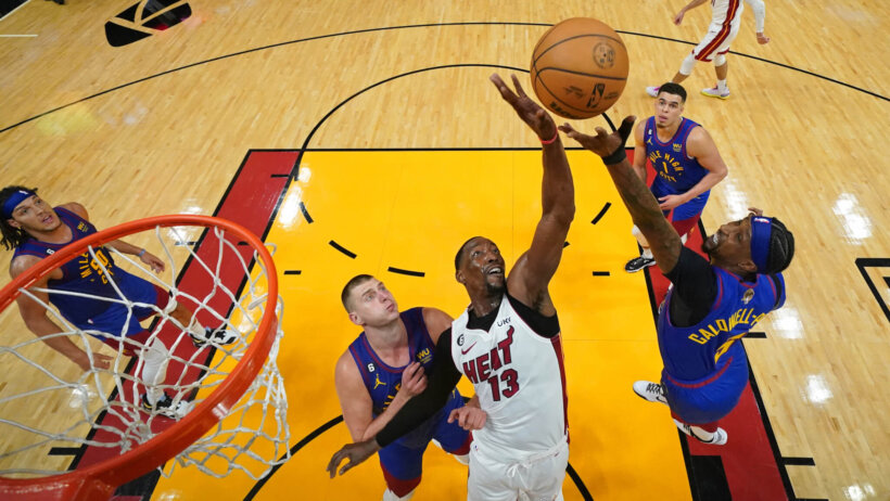 Kentavious Caldwell-Pope goes up for a loose ball with Bam Adebayo.