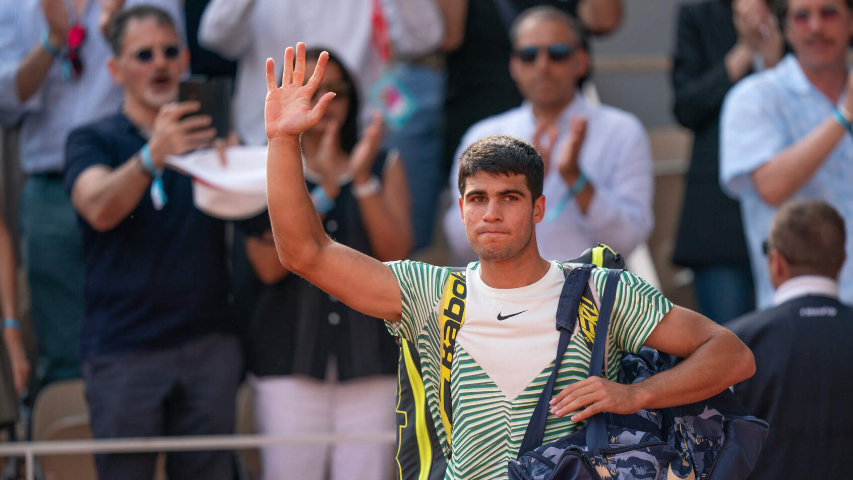 Carlos Alcaraz salutes the crowd at Roland Garros.