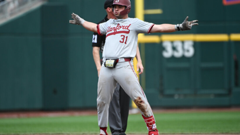 Carter Graham celebrates at second base with arms wide out after hit vs Wake Forest