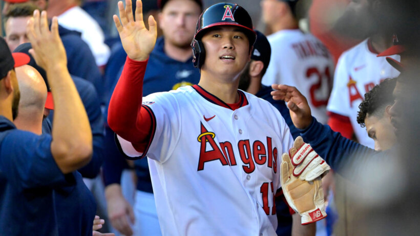 Shohei Ohtani celebrates in the dugout.