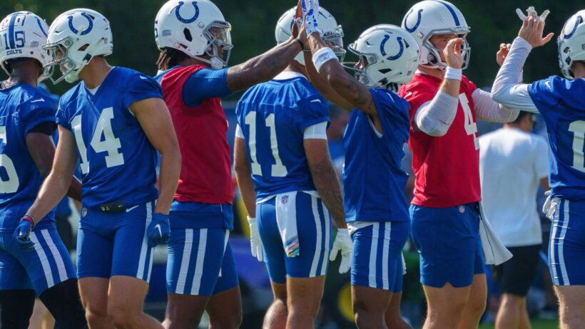 Anthony Richardson high-fives teammates at Colts training camp.