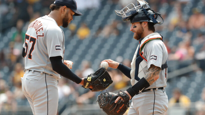 Detroit Tigers catcher Eric Haase hands the ball to pitcher Eduardo Rodriguez