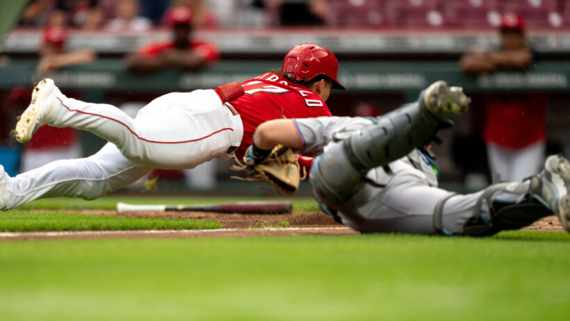 Stuart Fairchild slides head first into home vs the Marlins.