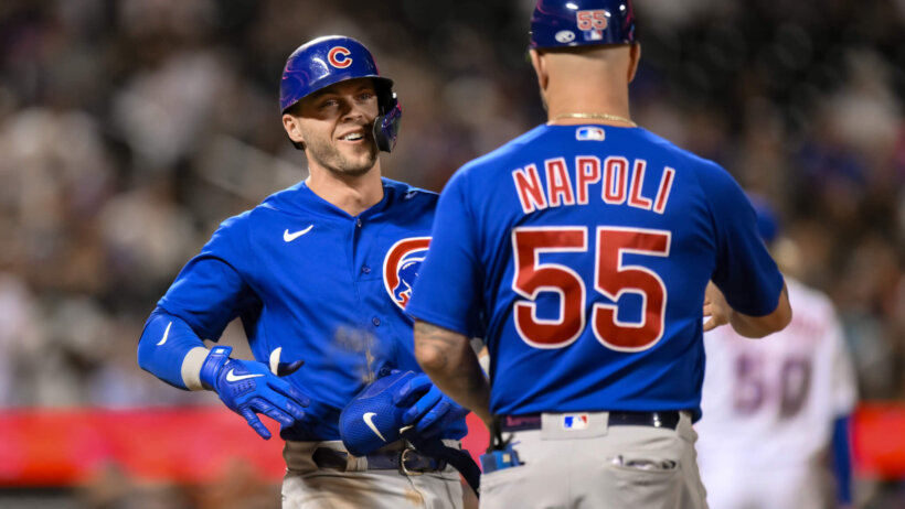 Chicago Cubs second baseman Nico Hoerner celebrating with first-base coach