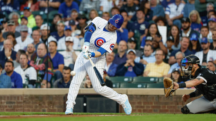 Chicago Cubs left fielder Ian Happ hitting a pitch against the Chicago White Sox