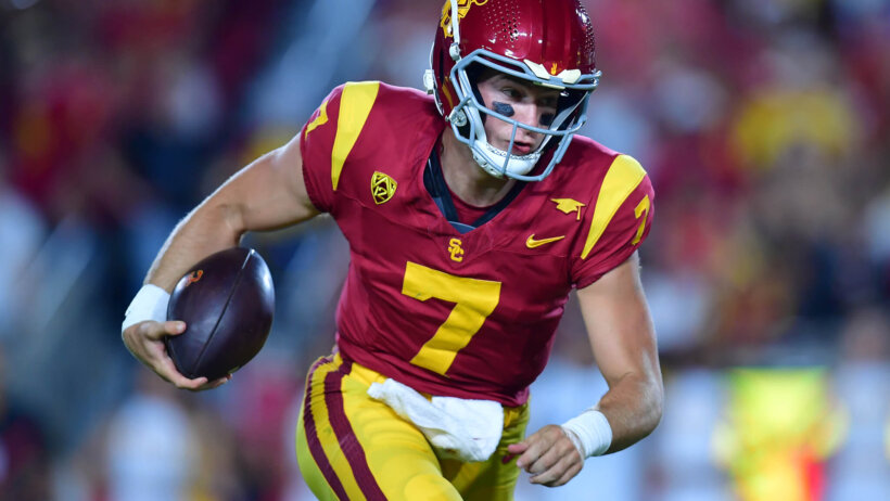 Southern California Trojans quarterback Miller Moss runs the ball
