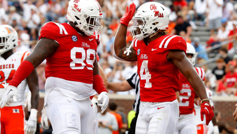 Ole Miss running back Quinshon Judkins reacts with Mississippi Rebels defensive linemen JJ Pegues