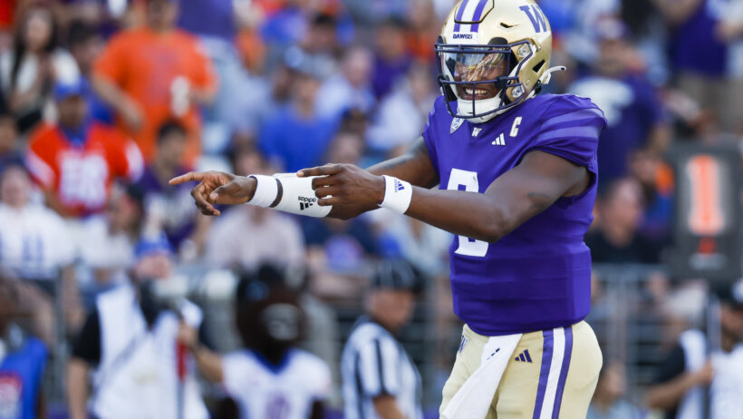 Washington Huskies quarterback Michael Penix Jr. celebrates after throwing a touchdown pass