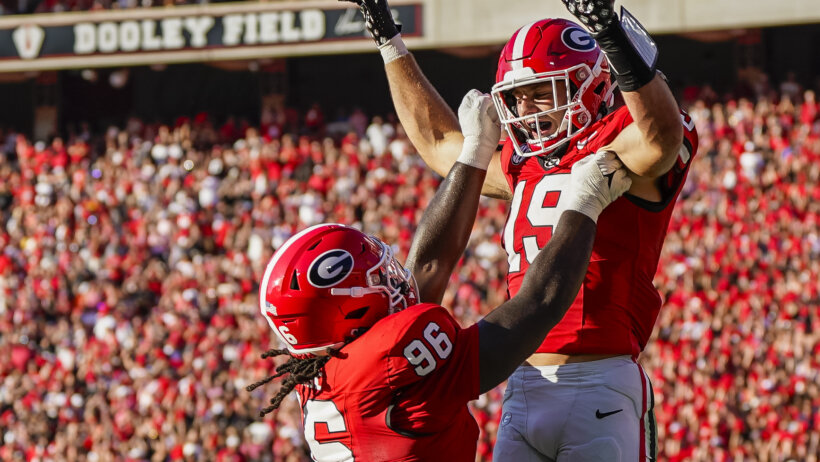 Georgia Bulldogs tight end Brock Bowers reacts with defensive lineman Zion Logue