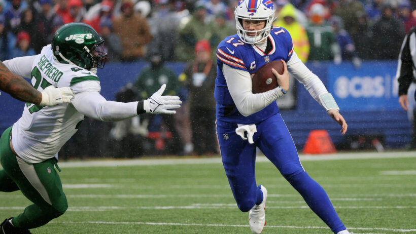 Bills quarterback Josh Allen avoids the tackle by Jets Nathan Shepherd.