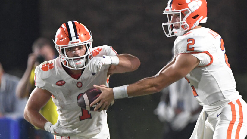 Clemson quarterback Cade Klubnik hands off to running back Will Shipley