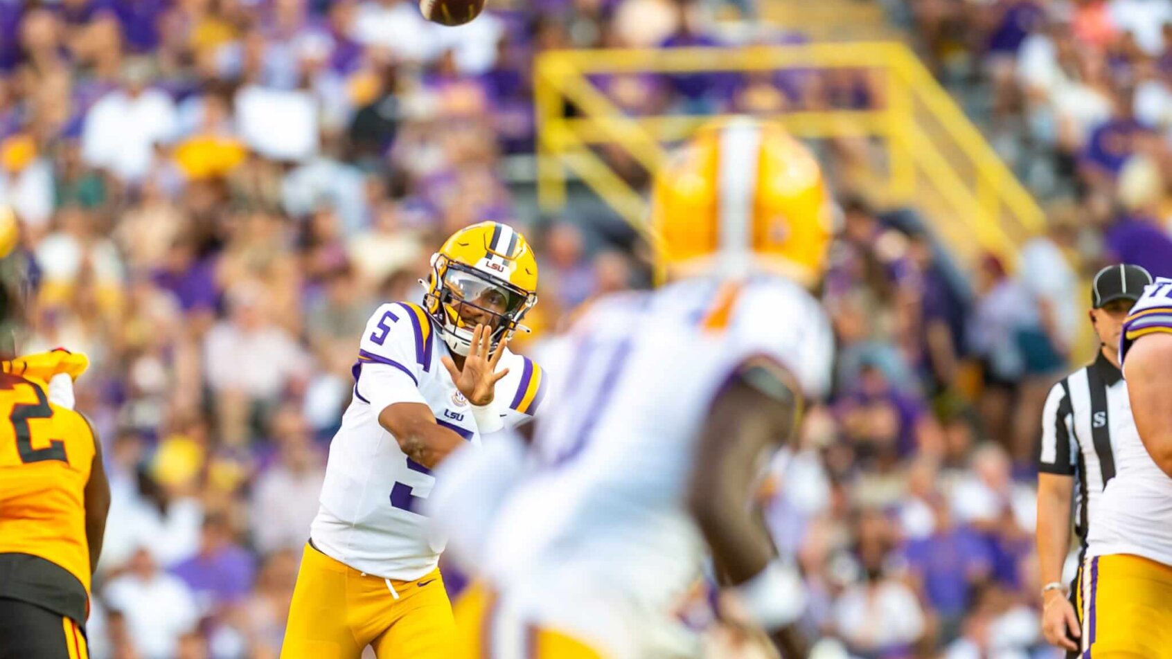 Tigers quarterback Jayden Daniels throwing a pass
