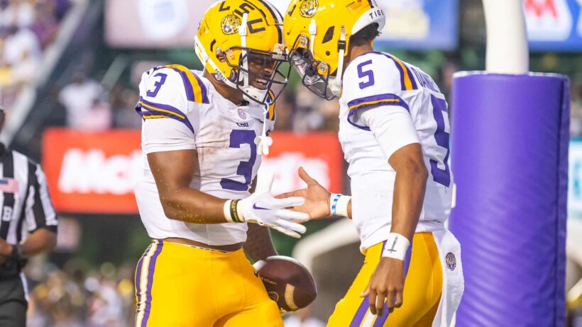Tigers Quarterback Jayden Daniels celebrates with Logan Diggs