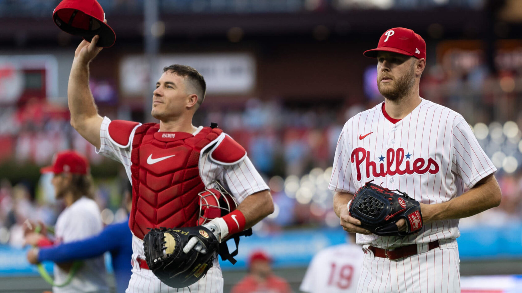 Philadelphia Phillies catcher J.T. Realmuto and starting pitcher Zack Wheeler walk onto the field