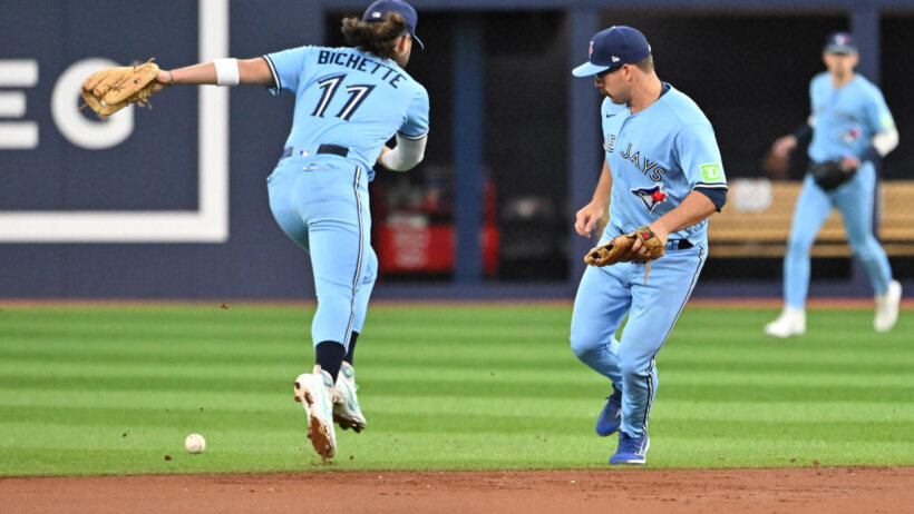 Toronto Blue Jays shortstop Bo Bichette and second baseman Davis Schneider misplay a ball