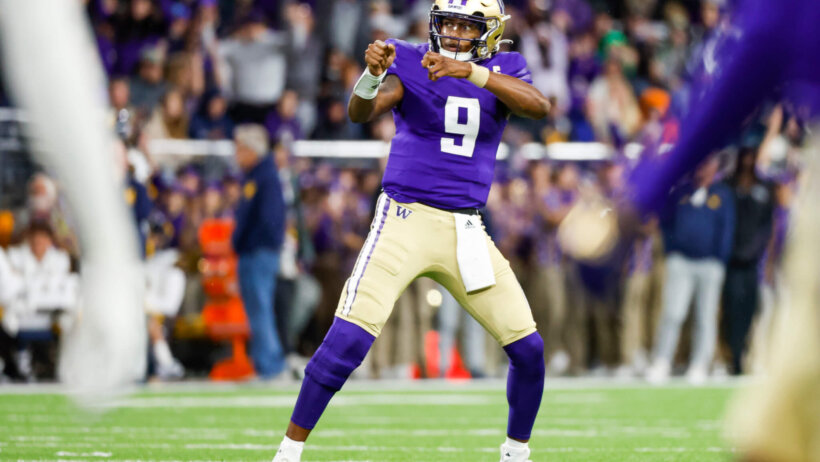Washington Huskies quarterback Michael Penix Jr. celebrates after throwing a touchdown pass