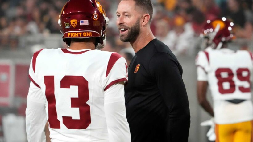 USC Trojans assistant coach Kliff Kingsbury talks to quarterback Caleb Williams