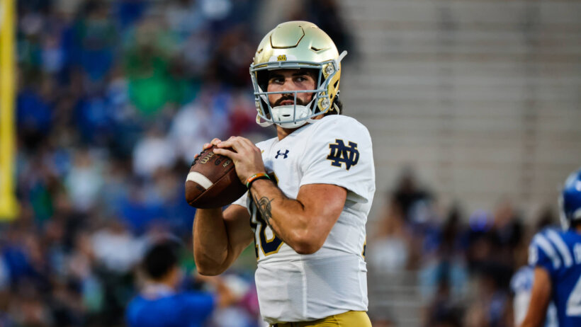 Notre Dame Fighting Irish quarterback Sam Hartman holds the football