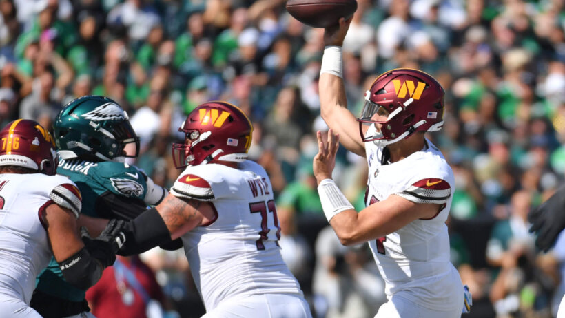 Washington Commanders quarterback Sam Howell (14) throws a pass