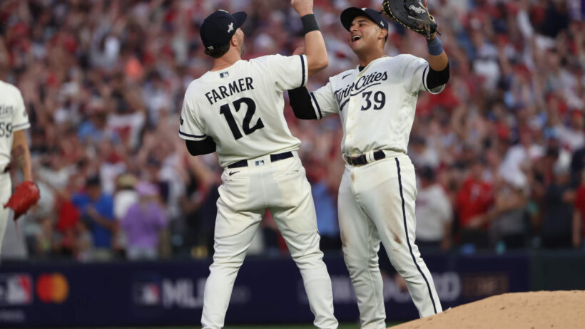 Minnesota Twins third baseman Kyle Farmer and first baseman Donovan Solano celebrate a win