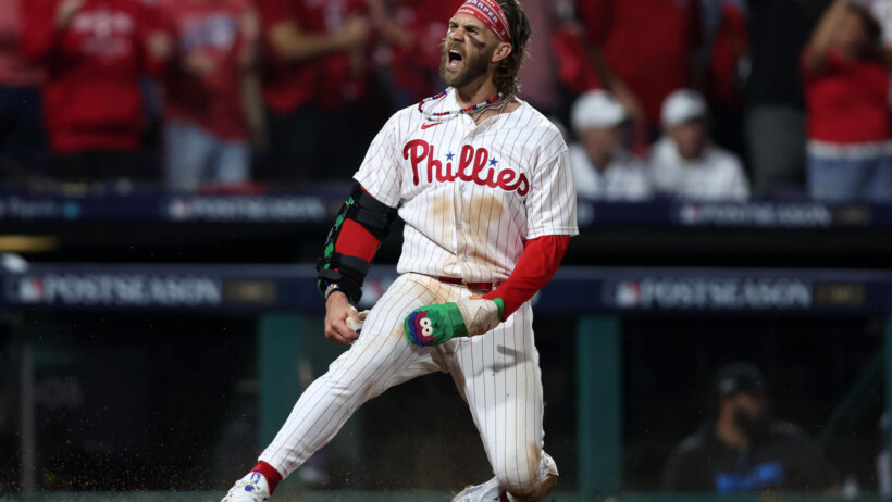Philadelphia Phillies designated hitter Bryce Harper scoring a run