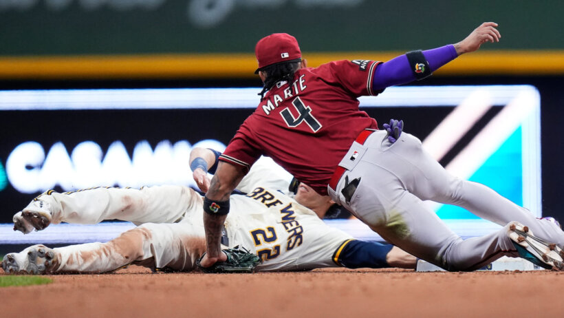Milwaukee Brewers left fielder Christian Yelich colliding with Arizona Diamondbacks second baseman Ketel Marte on the base path