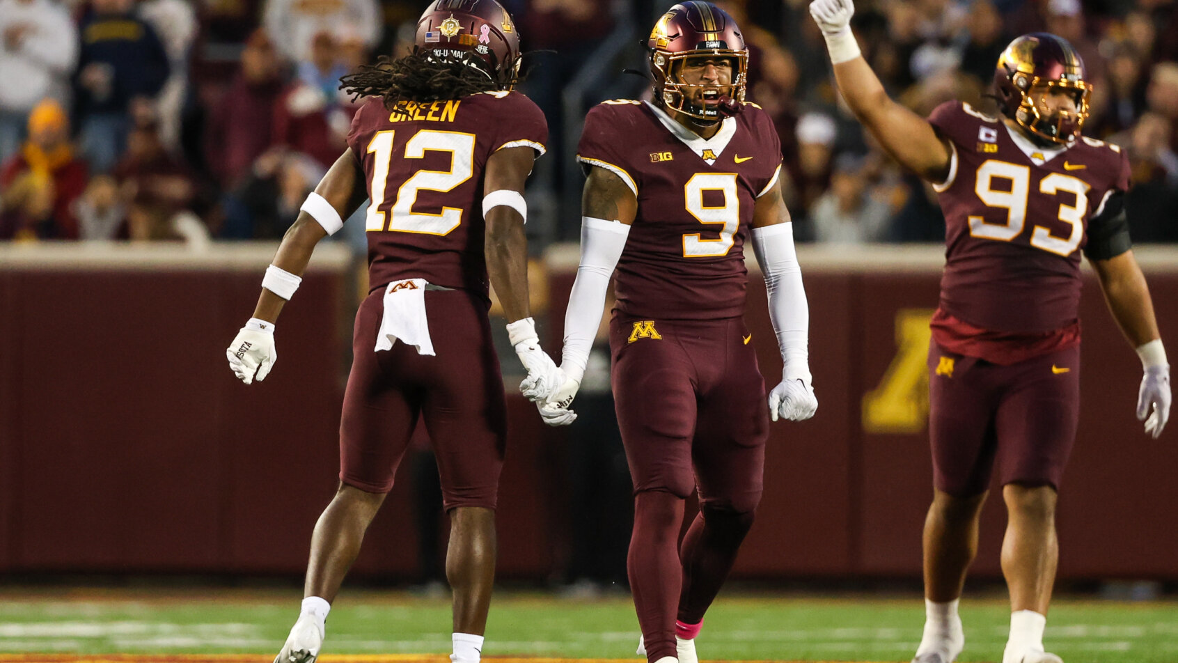 Minnesota Golden Gophers defensive back Darius Green and linebacker Devon Williams celebrate