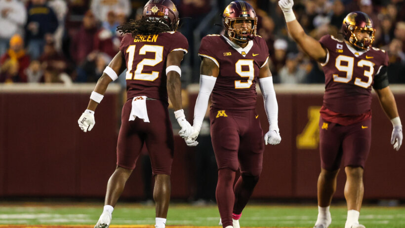 Minnesota Golden Gophers defensive back Darius Green and linebacker Devon Williams celebrate